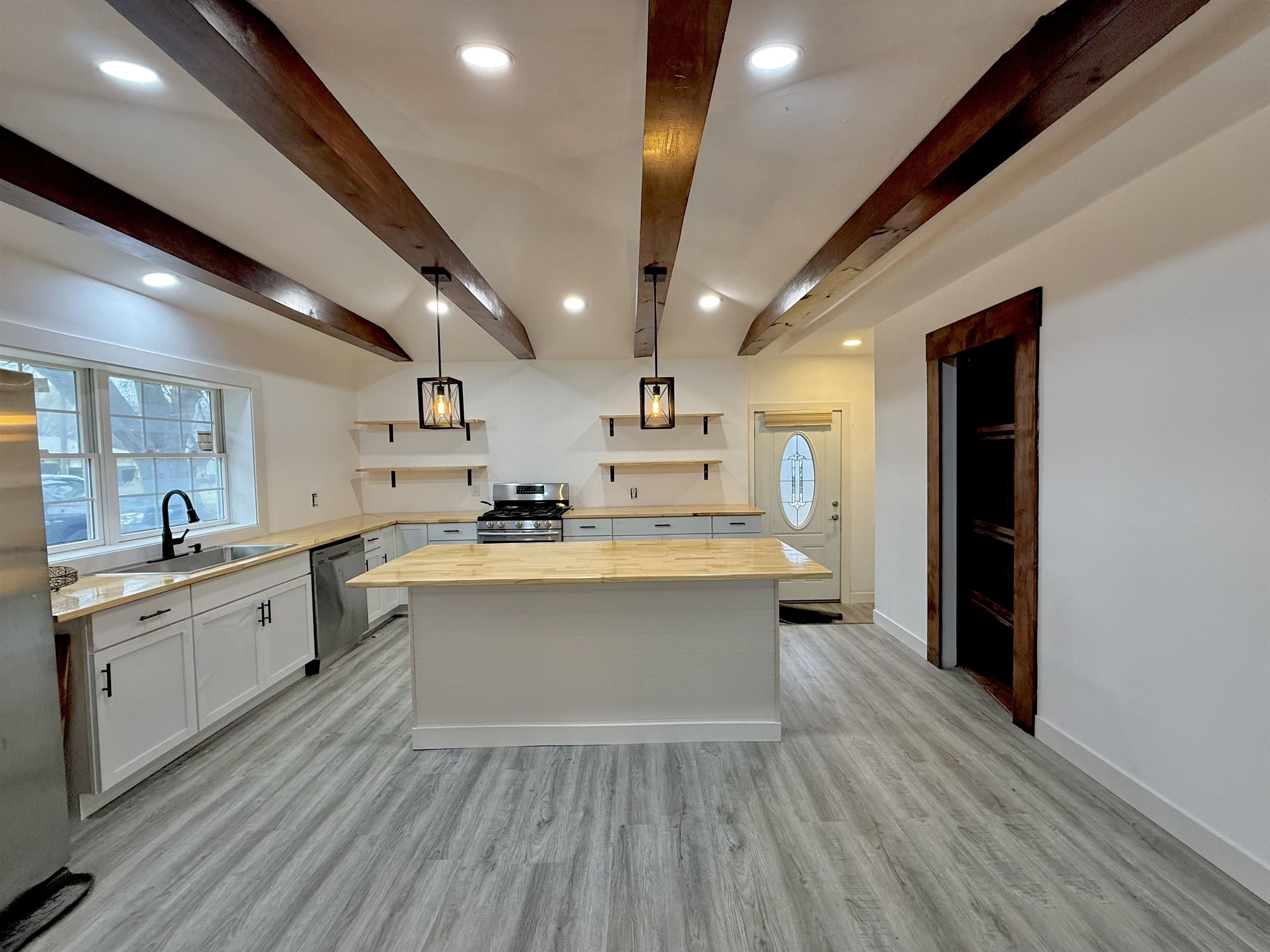 8432 Ravere Street Machesney Park, IL 61115 - Photo 5 of 31 a large kitchen with a lot of counter space and a sink
