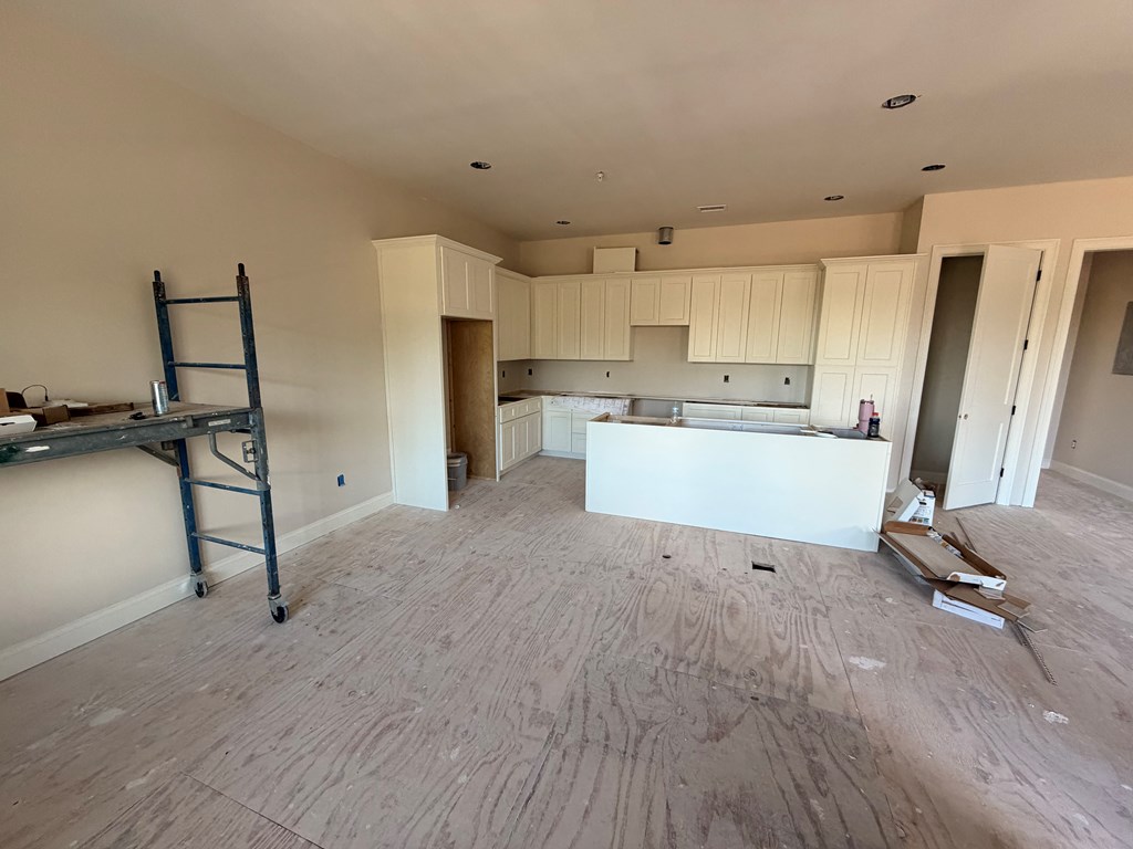 6801 River Road, Unit 406 Columbus, GA 31904 - Photo 5 of 10 a view of a kitchen with fridge and wooden floor