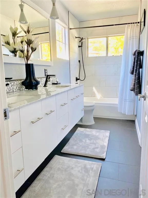 13609 Sunset View Road Poway, CA 92064 - Photo 12 of 15 a bathroom with a tub sink and mirror