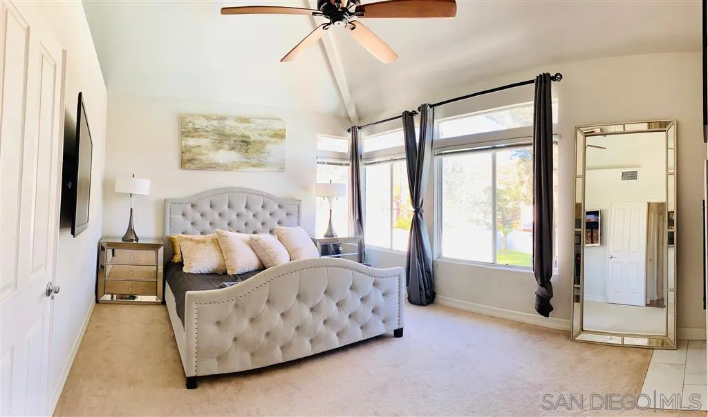 13609 Sunset View Road Poway, CA 92064 - Photo 8 of 15 a bedroom with bed and glass door