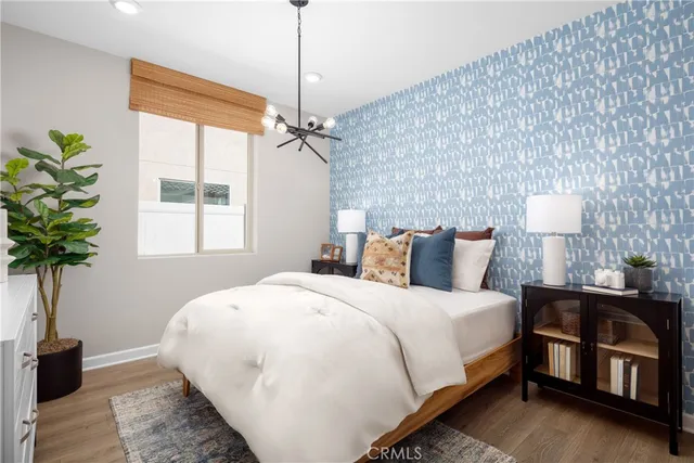 a bedroom with a bed lamp and a potted plant