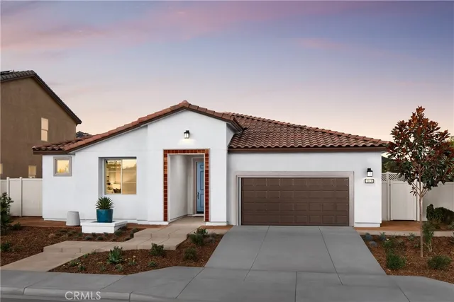 a front view of a house with yard and garage