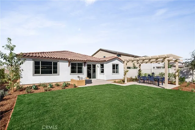 a front view of house with a garden