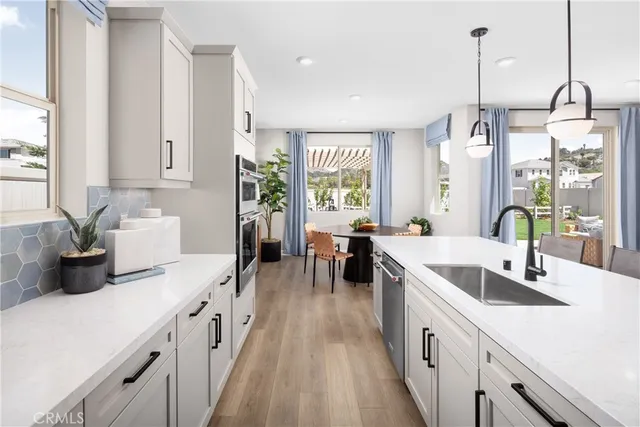 a kitchen with counter top space and windows