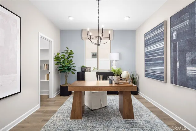 a dining room with furniture window and wooden floor