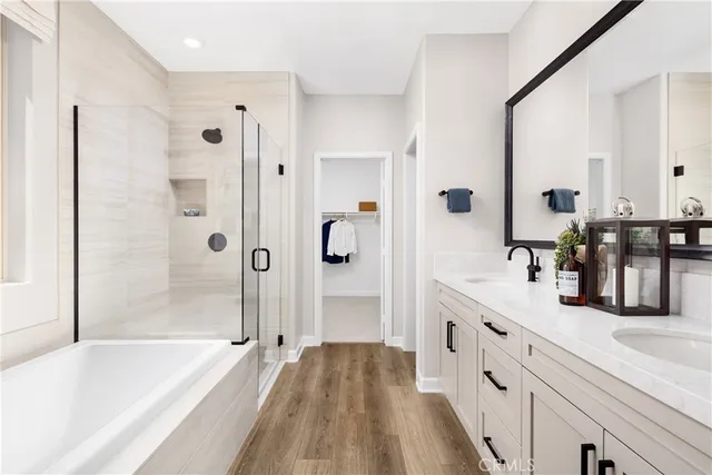 a spacious bathroom with a granite countertop tub sink and mirror
