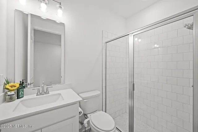 an aerial view of a house with a garden and lake view