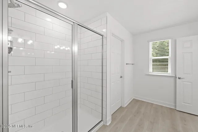 a front view of a house with a yard and potted plants