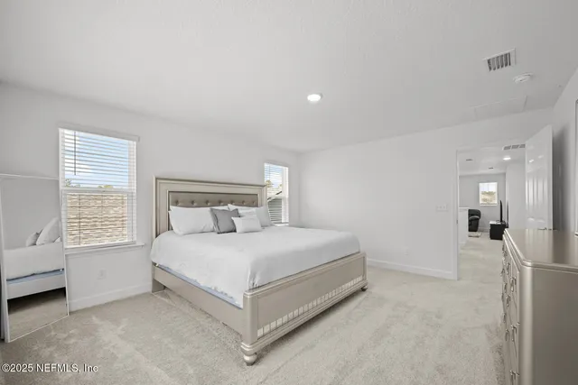 a view of a swimming pool and lounge chairs