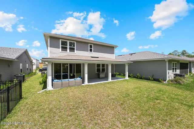 an aerial view of a house with a swimming pool