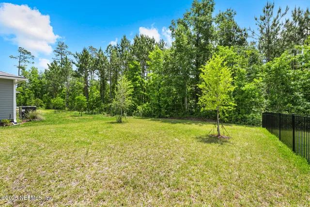 a living room with furniture and floor to ceiling windows