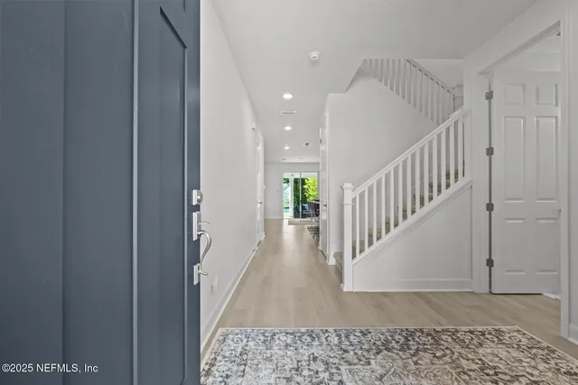 a large kitchen with kitchen island a sink stainless steel appliances and furniture