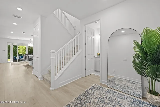 a view of a dining room with furniture wooden floor and chandelier