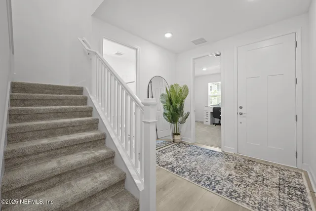 a view of a dining room with furniture wooden floor and chandelier