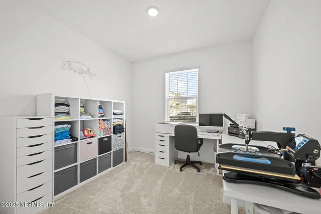 a view of a dining room and livingroom with furniture wooden floor a chandelier