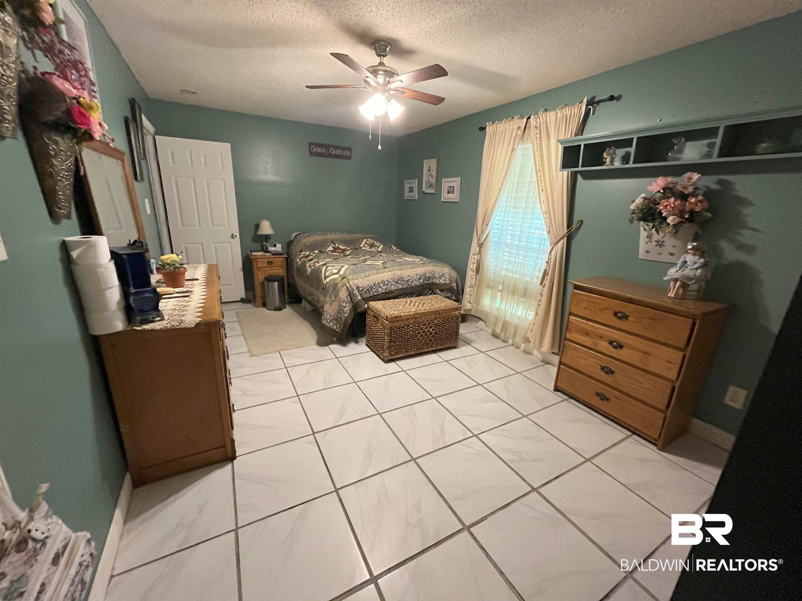 7851 Highway 98 Fairhope, AL 36532 - Photo 11 of 40 Bedroom with a textured ceiling and ceiling fan