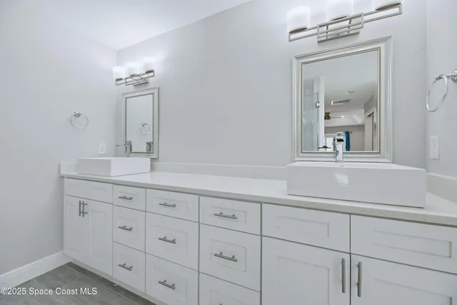 a bathroom with a sink vanity and mirror