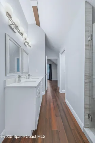 a spacious bathroom with a sink and a mirror