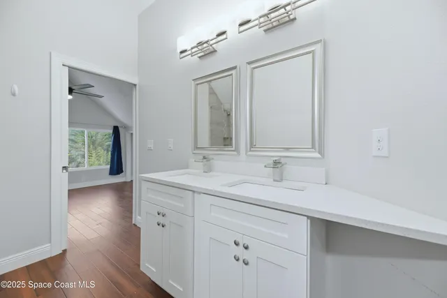 a bathroom with a double vanity sink and a mirror