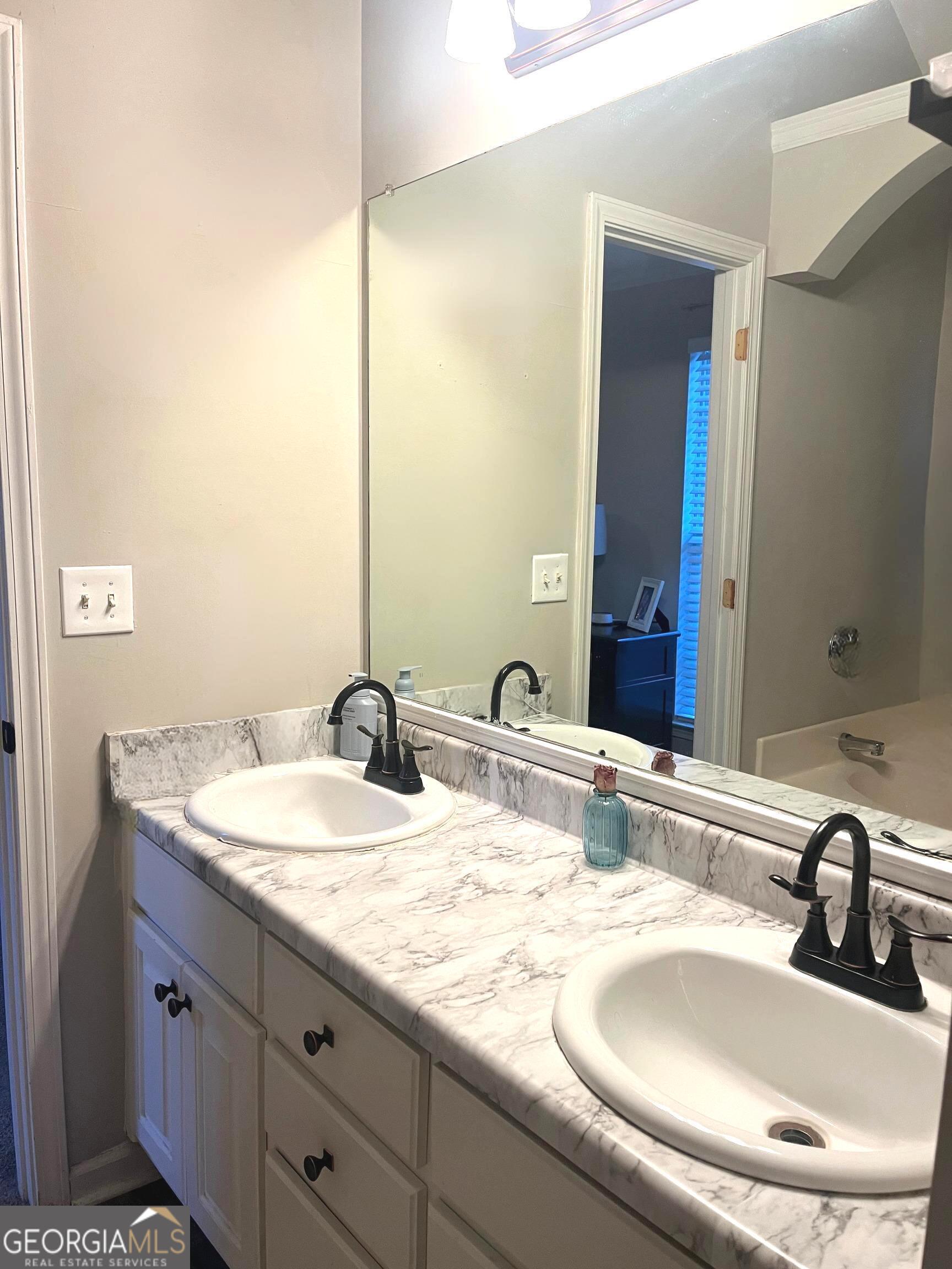 803 Lazy Lane Winder, GA 30680 - Photo 11 of 16 a bathroom with a granite countertop sink and a mirror