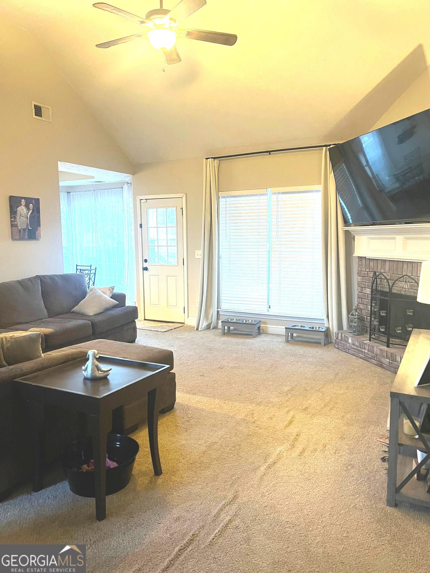 803 Lazy Lane Winder, GA 30680 - Photo 2 of 16 a living room with a couch and a table