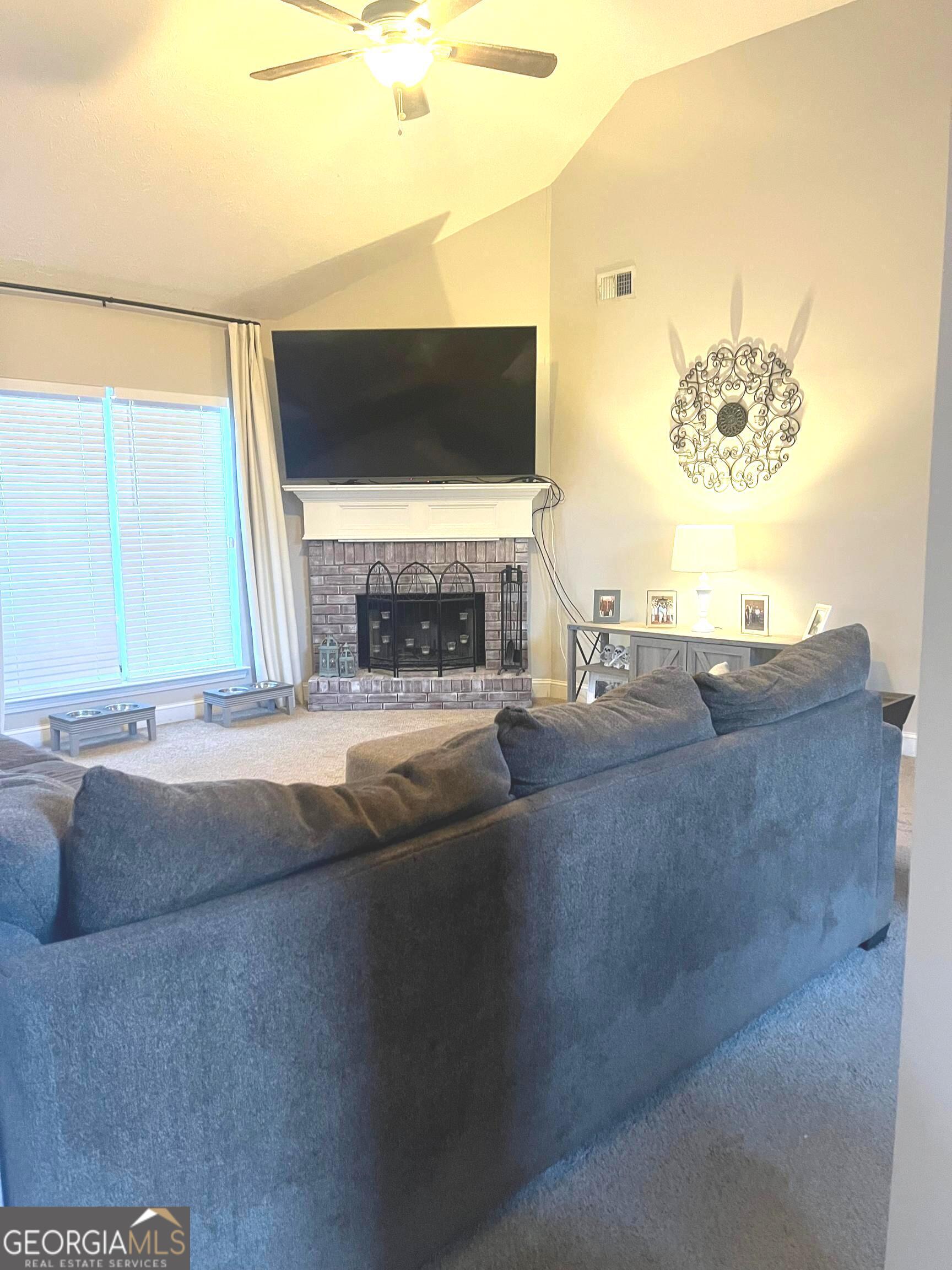 803 Lazy Lane Winder, GA 30680 - Photo 3 of 16 a living room with fireplace and a fireplace