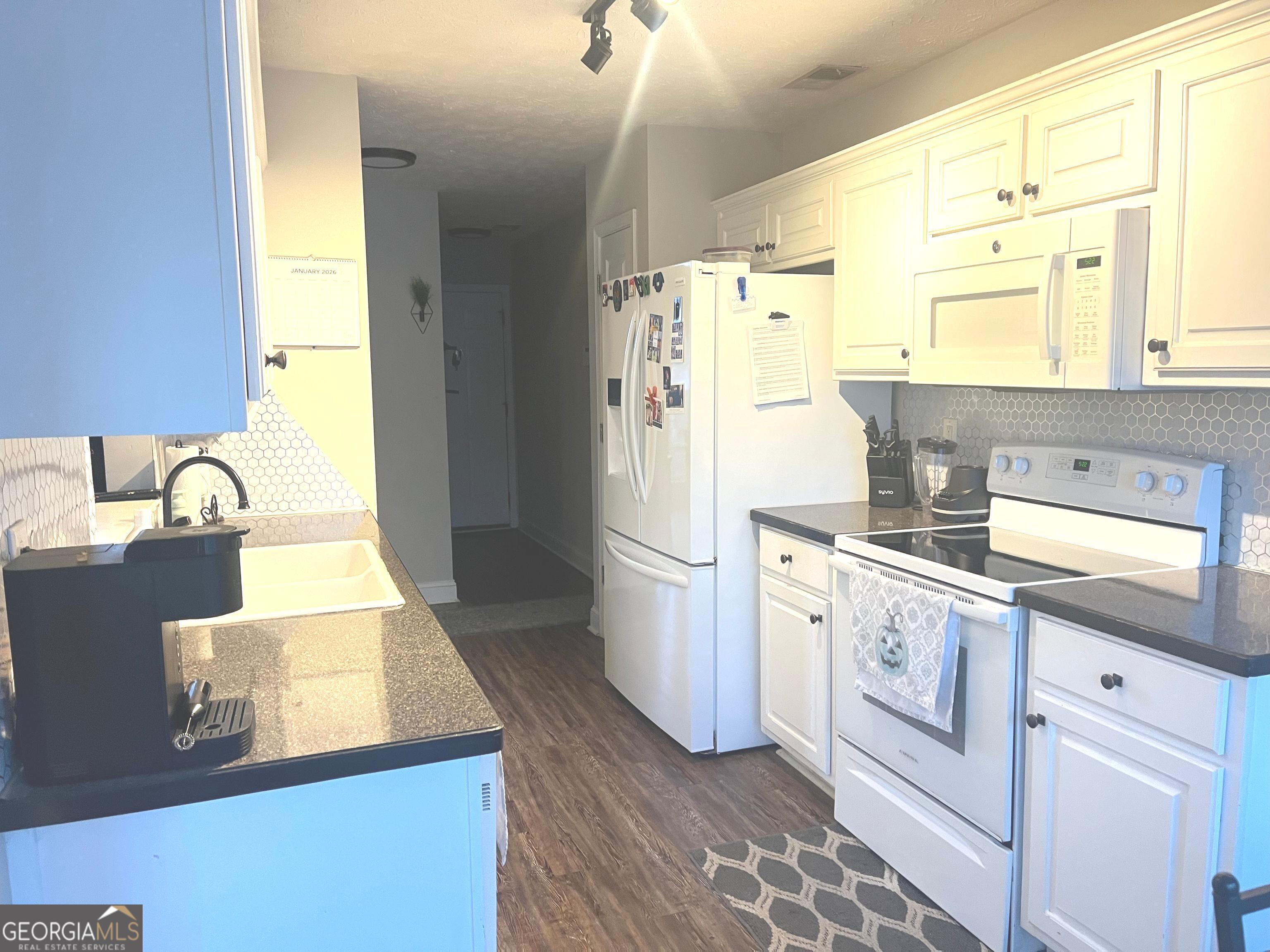 803 Lazy Lane Winder, GA 30680 - Photo 6 of 16 a kitchen with a sink a stove a refrigerator and a window