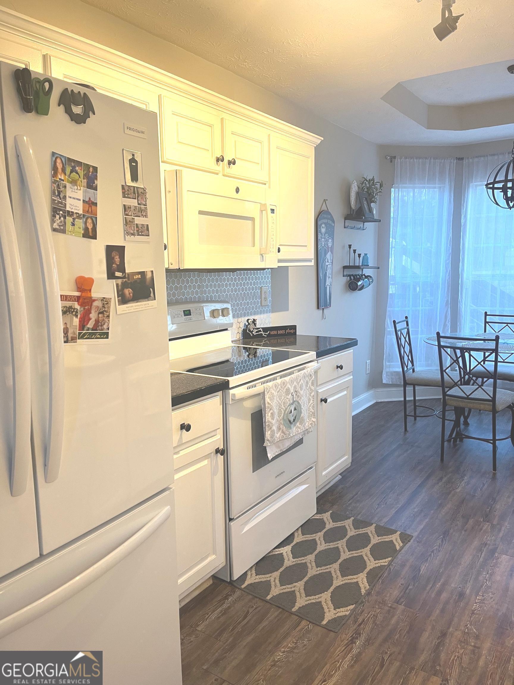 803 Lazy Lane Winder, GA 30680 - Photo 7 of 16 a kitchen with a stove a sink and a refrigerator