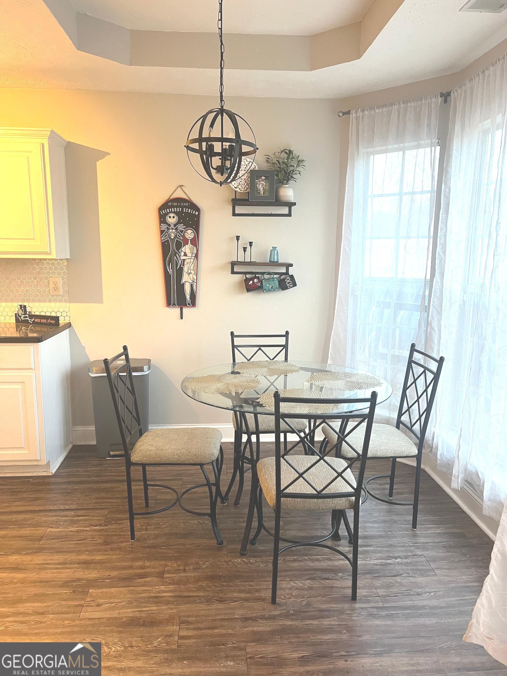803 Lazy Lane Winder, GA 30680 - Photo 9 of 16 a view of a dining room with furniture wooden floor and chandelier