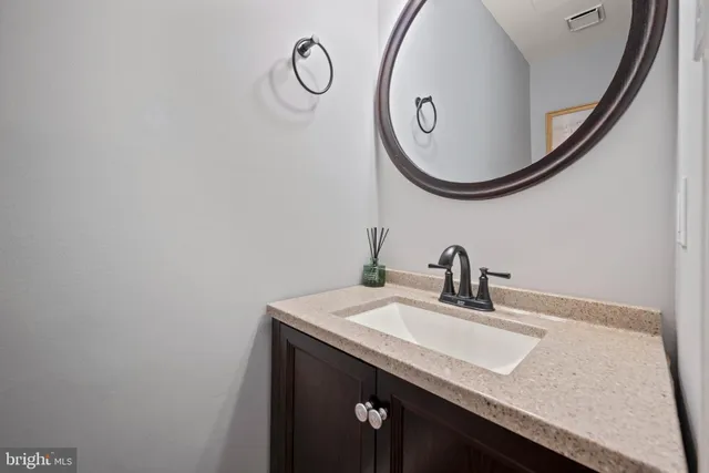 a kitchen with stainless steel appliances white cabinets and a stove top oven