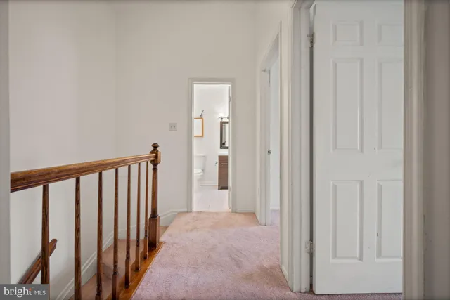 an empty room with closet and a chandelier fan