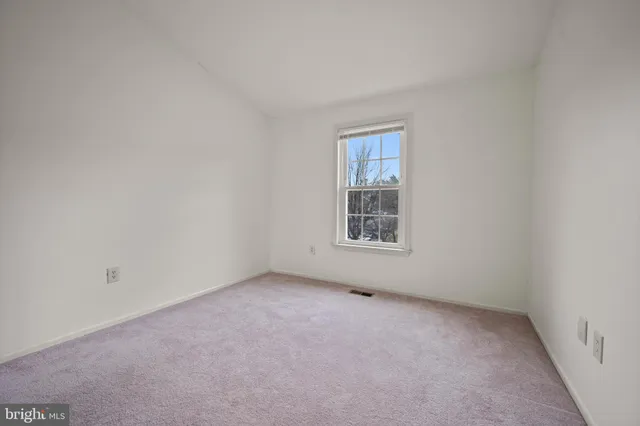 a view of an empty room and closet area