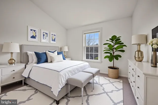 a bedroom with a bed and a mirror