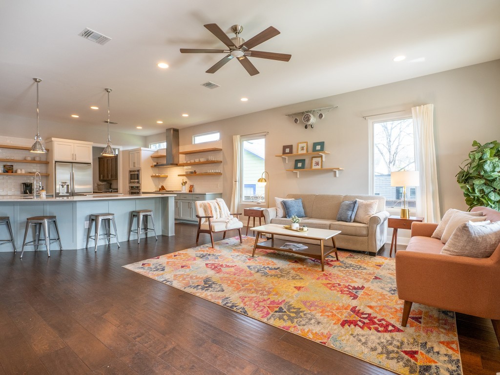 a living room with furniture and kitchen view