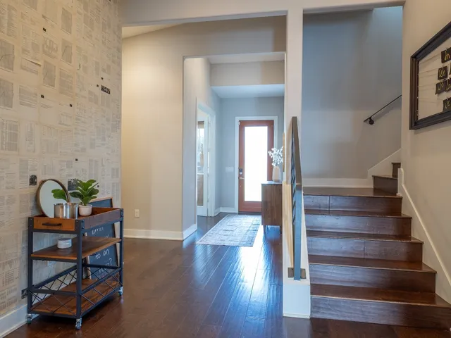 a view of an entryway with wooden floor and windows