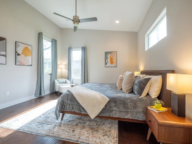 a bedroom with a bed a couch and a window