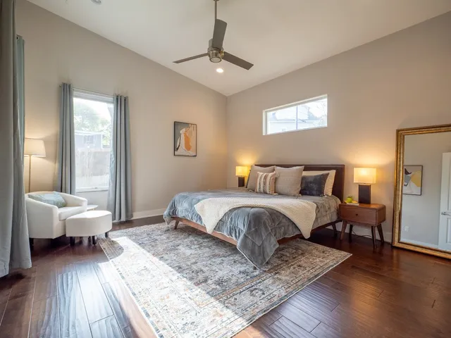 a bedroom with a bed and a potted plant