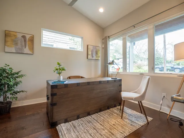 a dining room with furniture and a window