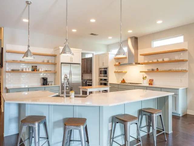 a kitchen with stainless steel appliances a sink and cabinets