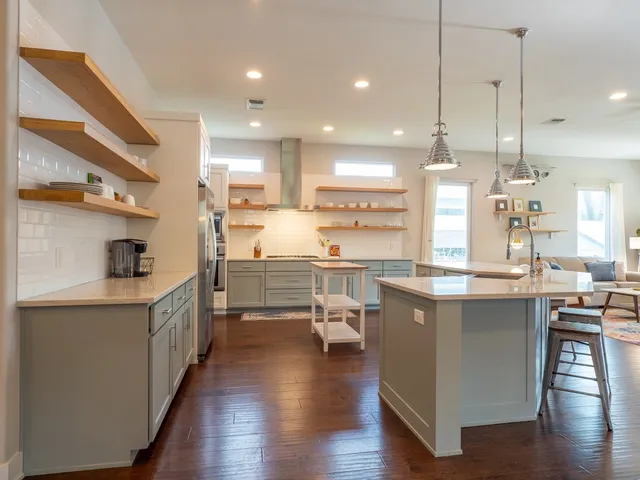 a kitchen with counter top space a sink appliances and cabinets