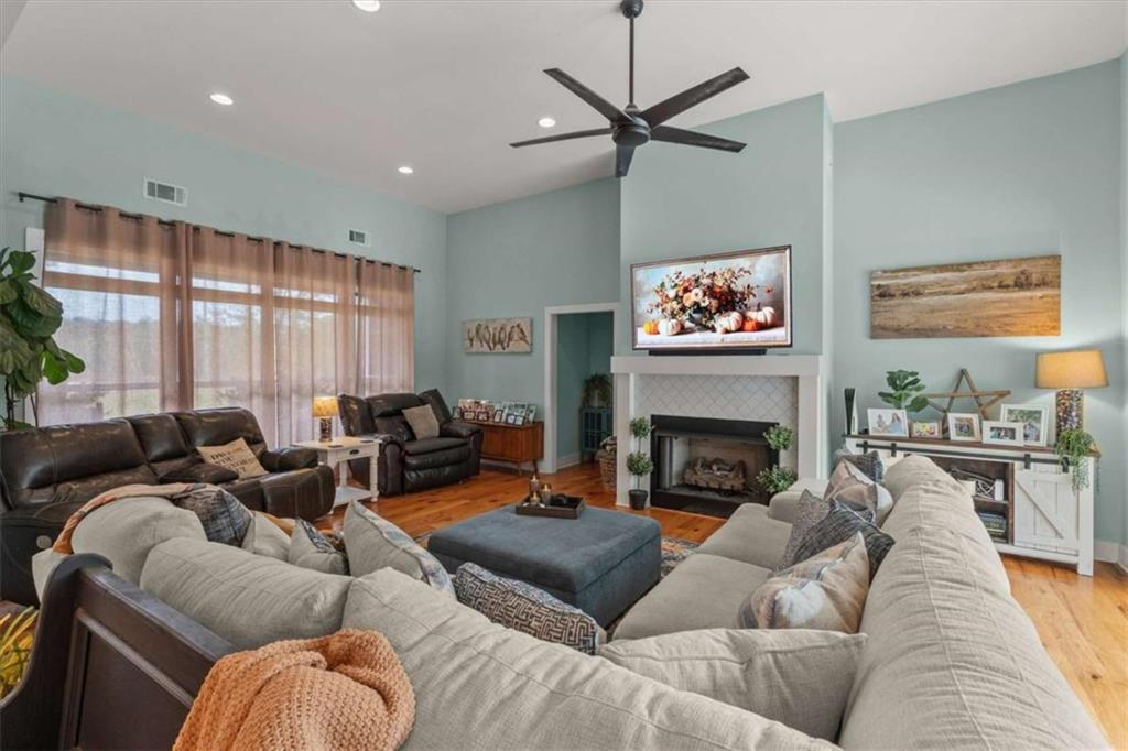 1233 Whooping Creek Road Carrollton, GA 30116 - Photo 12 of 61 a living room with furniture a fireplace and a large window