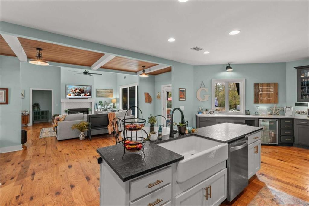 1233 Whooping Creek Road Carrollton, GA 30116 - Photo 16 of 61 a kitchen with stainless steel appliances granite countertop a sink and a refrigerator