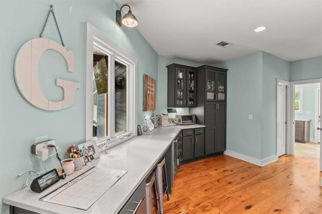 1233 Whooping Creek Road Carrollton, GA 30116 - Photo 19 of 61 a kitchen with kitchen island a sink stove and a refrigerator
