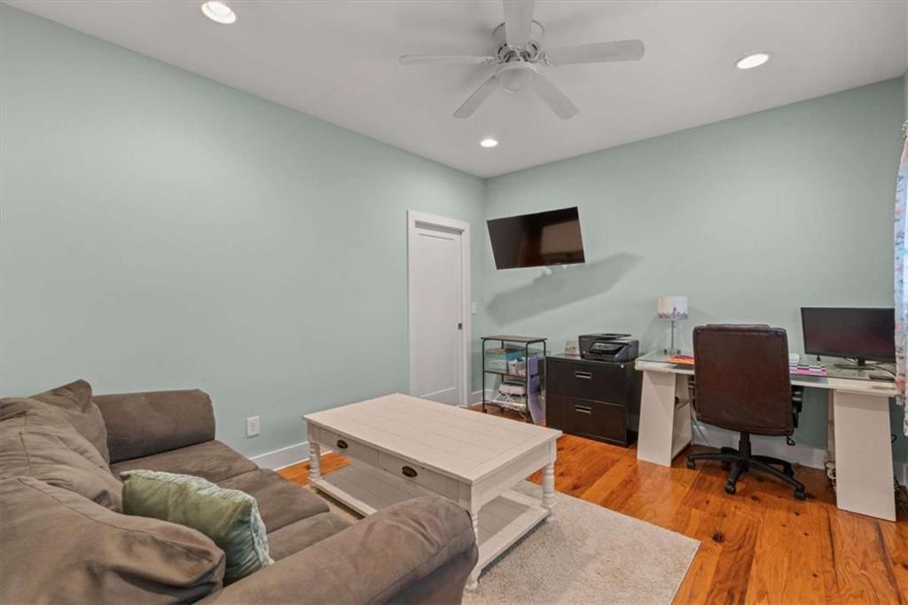 1233 Whooping Creek Road Carrollton, GA 30116 - Photo 20 of 61 a living room with furniture and a flat screen tv