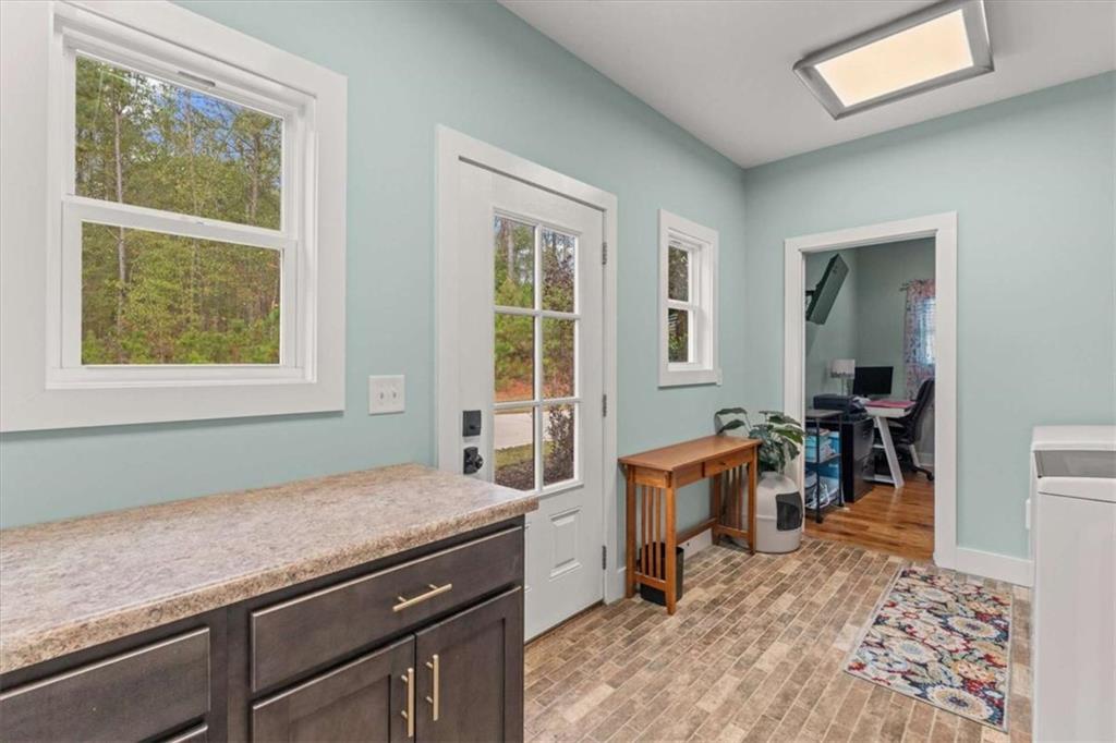 1233 Whooping Creek Road Carrollton, GA 30116 - Photo 22 of 61 a view of a kitchen area with furniture and window