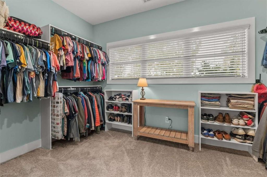 1233 Whooping Creek Road Carrollton, GA 30116 - Photo 30 of 61 a view of walk in closet with clothes and shoes