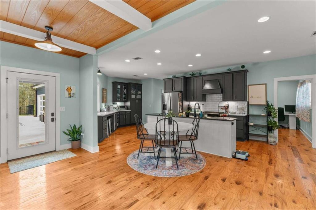 1233 Whooping Creek Road Carrollton, GA 30116 - Photo 3 of 61 a kitchen with a refrigerator dining table and chairs