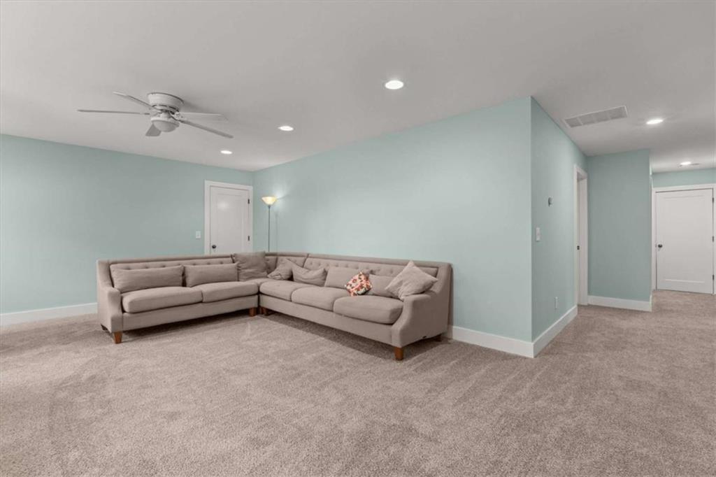 1233 Whooping Creek Road Carrollton, GA 30116 - Photo 32 of 61 a living room with furniture and a ceiling fan