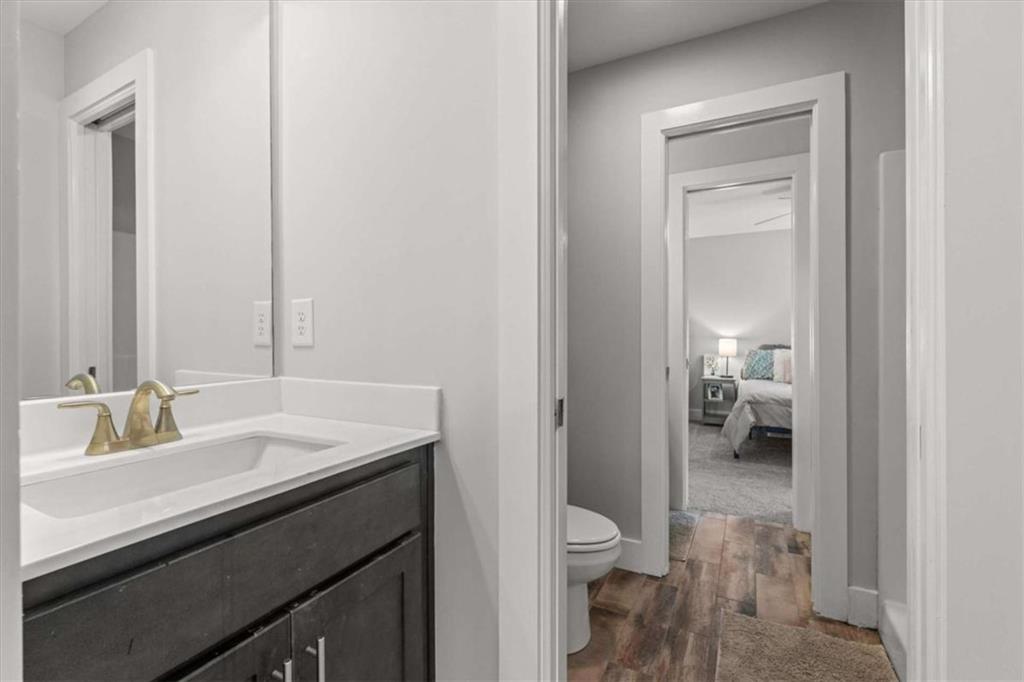 1233 Whooping Creek Road Carrollton, GA 30116 - Photo 36 of 61 a en suite bathroom with a sink a toilet and a mirror