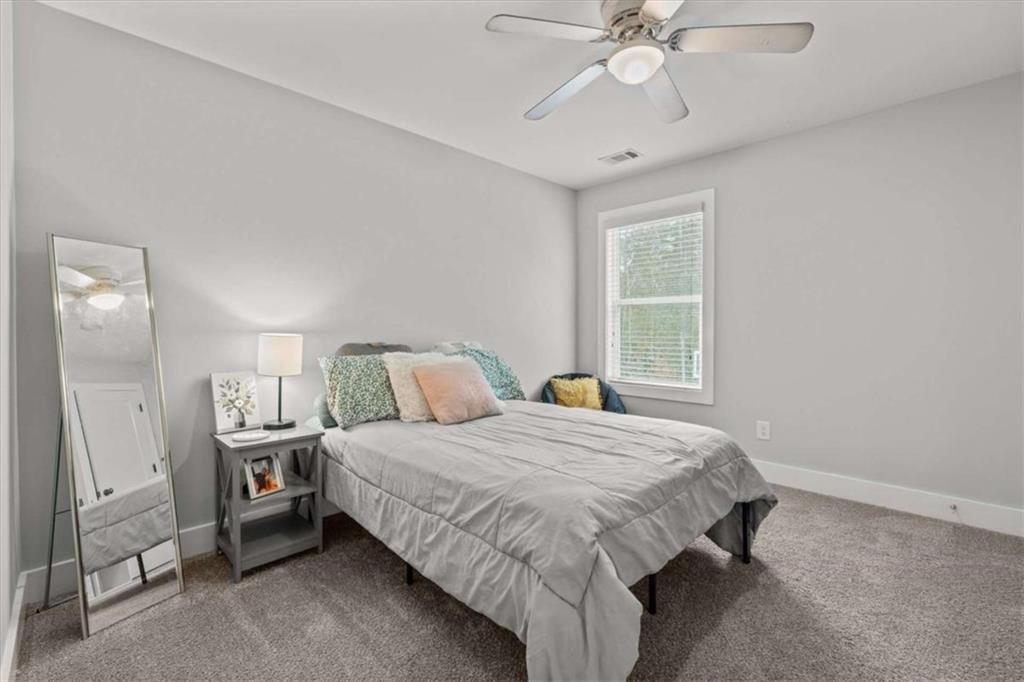 1233 Whooping Creek Road Carrollton, GA 30116 - Photo 39 of 61 a bedroom with a bed and a window